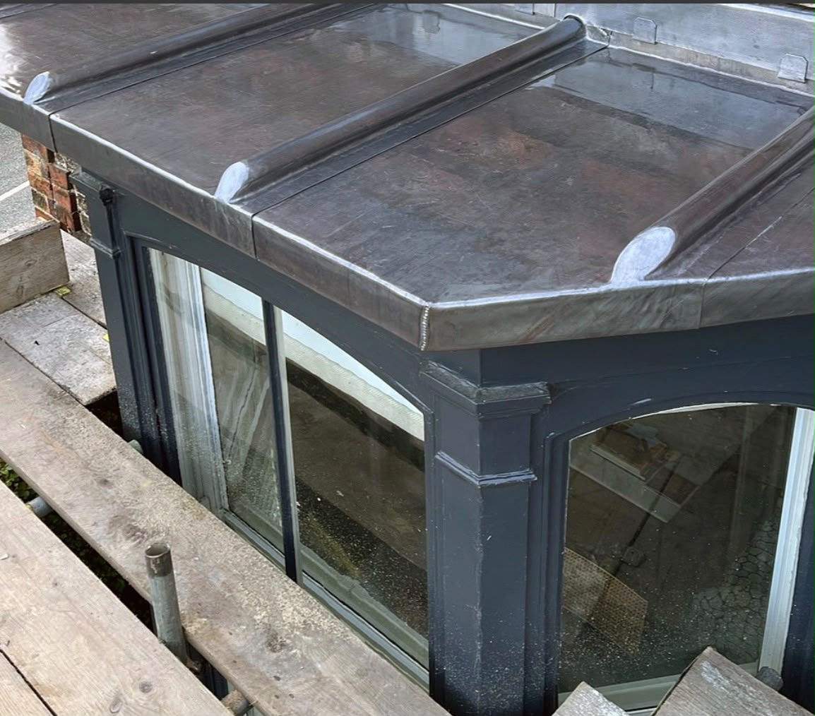 New code-lead flashing dressed over a bay window roof to a watertight finish