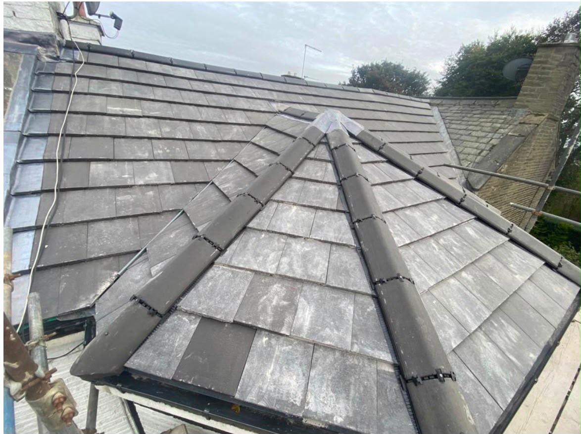 Slate hip roof detail with lead soakers and dressed flashings